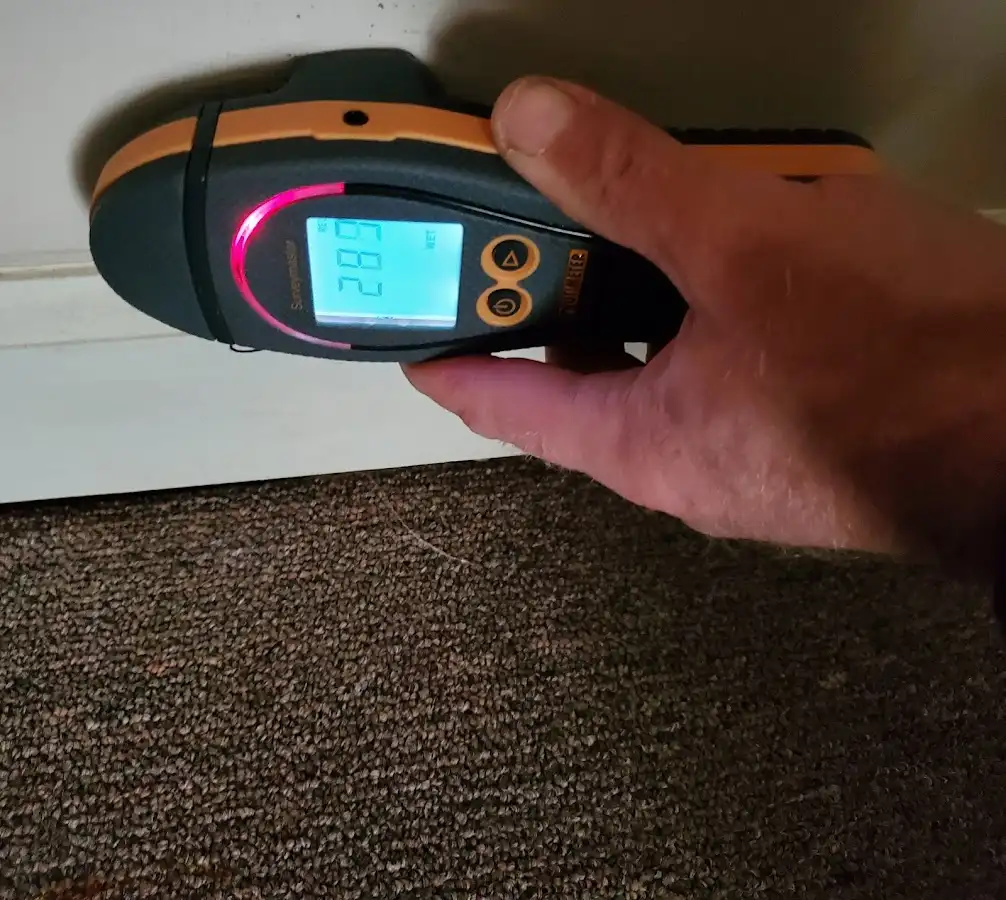 Moisture detection at baseboard during Storm Damage Restoration in Port Washington